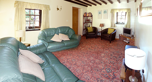 Bide-A-Wee cottage's living room is equipped with comfy sofas, Sky Freesat TV, coal-effect electric fire, and a selection of books and games, making it the perfect place to lounge after a day of sightseeing and activities.